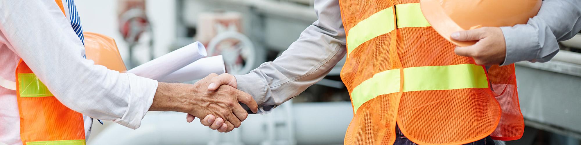construction workers shake hands
